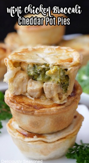 A stack of three mini pot pies with chicken, broccoli and cheese in them.