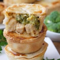A small stack of three pot pies on top of each other with the top one showing the inside ingredients.