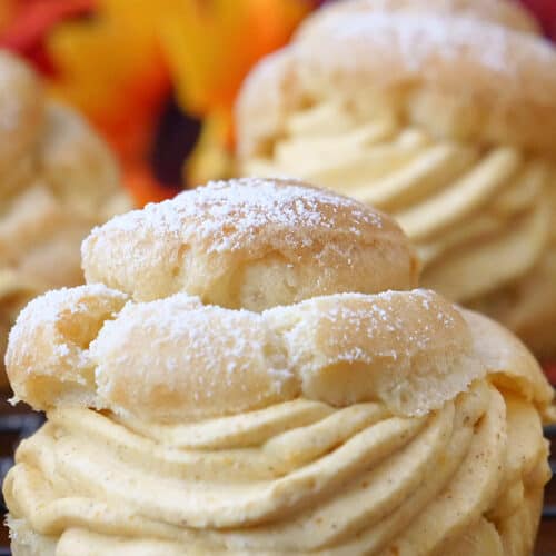 A close up of pumpkin mousse filled cream puffs with the title of the recipe at the top of the photo.