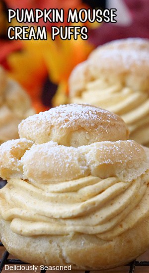 A close up of a cream puff filled with pumpkin mousse.