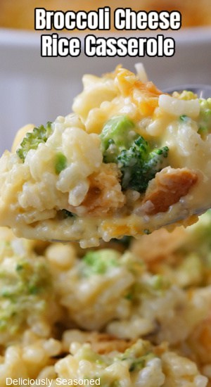 A close up of a spoonful of broccoli cheese rice casserole.