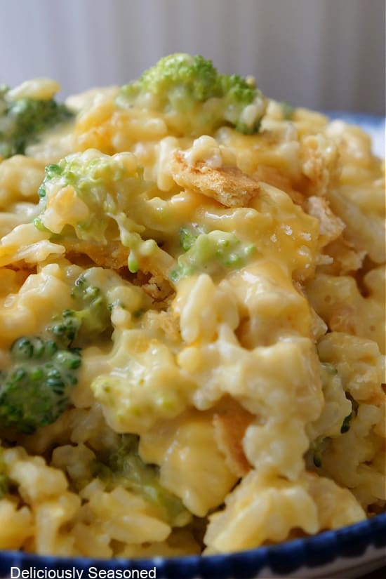 A close up photo of cheesy rice with broccoli.