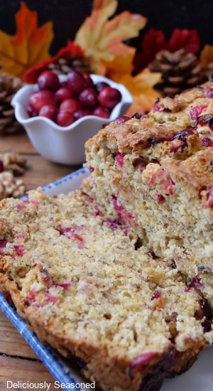 A close up of a slice of cranberry walnut bread.
