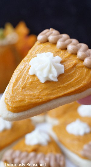 A close up of a sugar cookie pumpkin pie slice.