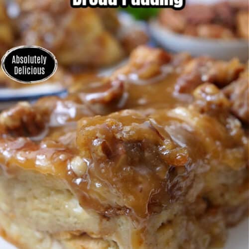A serving of caramel pecan bread pudding on a white plate with blue trim.