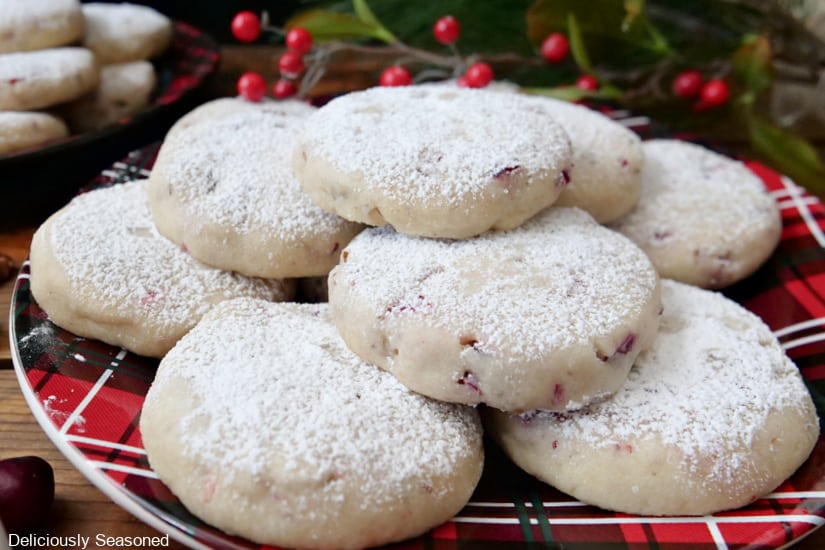 Cranberry pecan sandies on a red and black plaid plate.