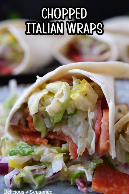 A close up of a chopped Italian wrap showing the meats and lettuce mixture with a flour tortilla.