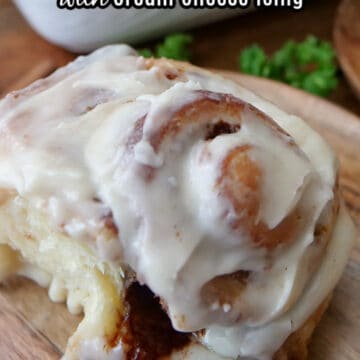 A close up of a homemade cinnamon roll with cream cheese icing.