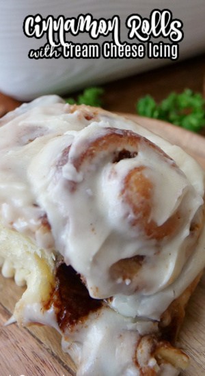 A close up of a cinnamon roll with icing on it.