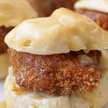 A close up of a mini chicken biscuit with honey butter, and the title of the recipe at the top of the photo.