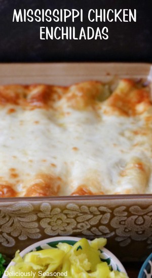 A casserole dish filled with baked chicken enchiladas.