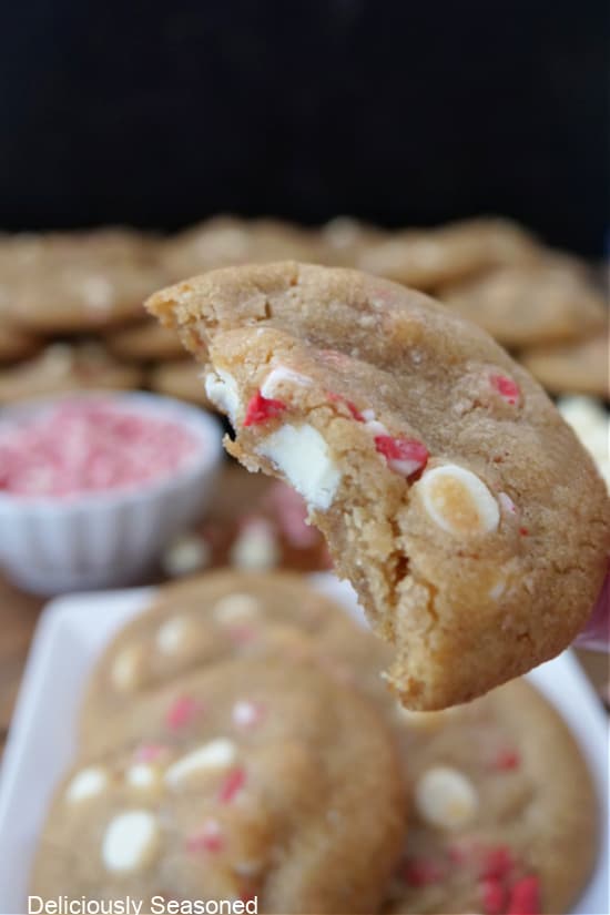 A close up of a cookie with a bite taken out of it.
