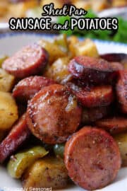 A close up of sliced sausage and potatoes.