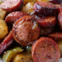 A close up of smoked sausage and diced potatoes.