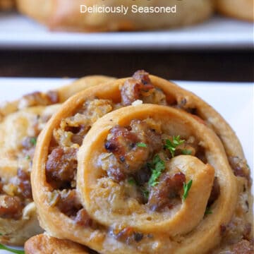 A close up of an Italian sausage pinwheel on a white plate.