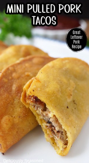 A few mini fried tacos on a white plate with a bite taken out of the one in front.