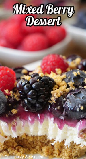 A close up of a slice of mixed berry dessert.