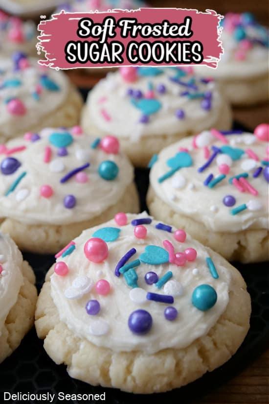 Mini sugar cookies with white frosting and candy sprinkles on top.