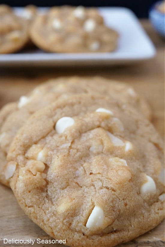 A close up photo of a white chocolate macadamia nut cookie.
