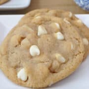 A close up photo of two cookies on a white plate.