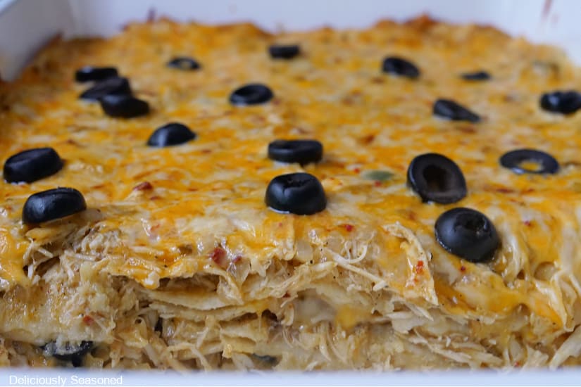A baking dish with chicken lasagna showing the layers.
