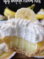 A close up of a mini banana cream pie with a big bite taken out of it.