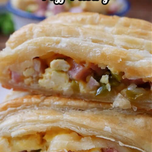 A close up photo of two slices of ham egg and cheese puff pastry.
