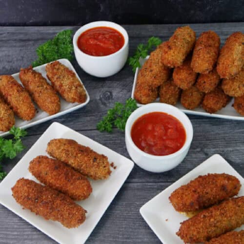 White plates with fried spicy mozzarella sticks on them with the title in text at the top of the photo.