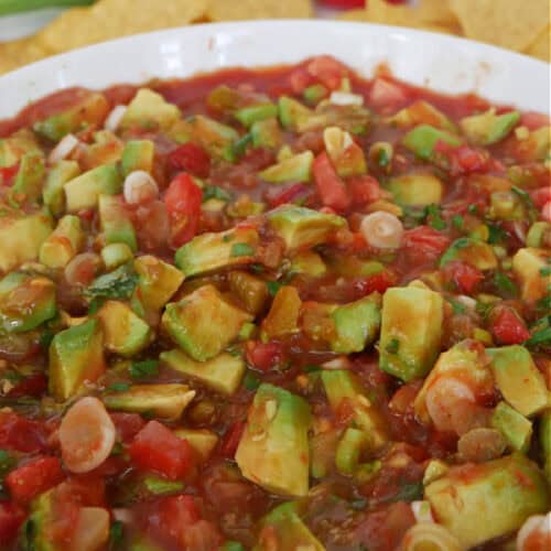 Chunky avocado salsa in a white bowl.