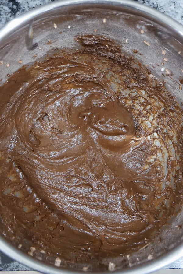 A silver bowl with the thick chocolate pudding mixture in it.