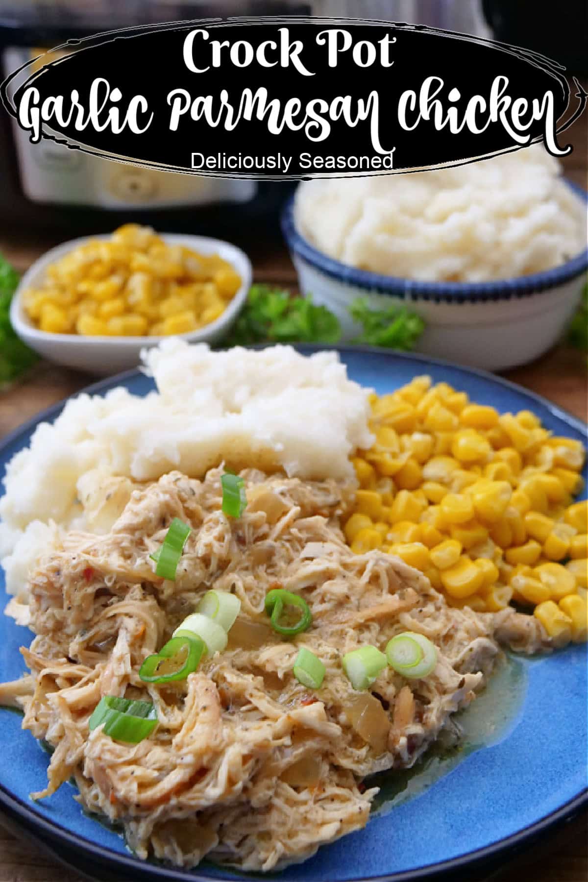 A round blue plate with shredded chicken, mashed potatoes, and corn on it.