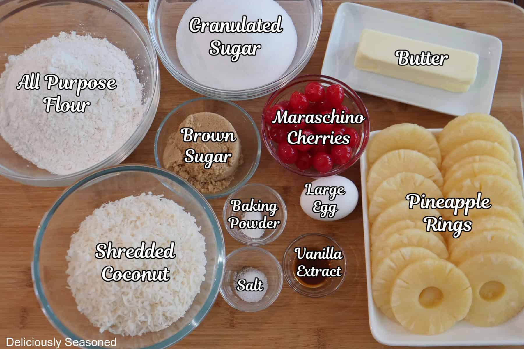 A wood surface with all the ingredients on it to make pineapple upside down cookies.