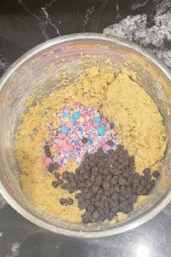 The wet and dry ingredients mixed together with springs sprinkles and mini chocolate chips added.