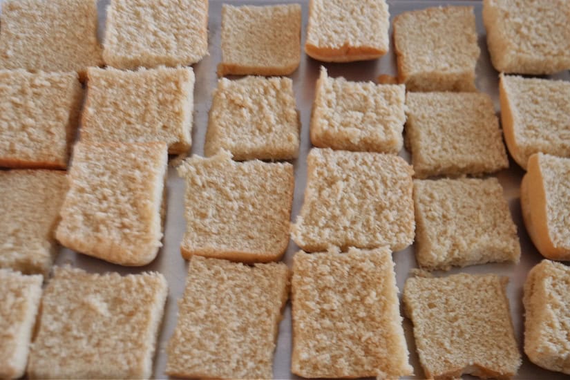 Toasted slider buns on a baking sheet.