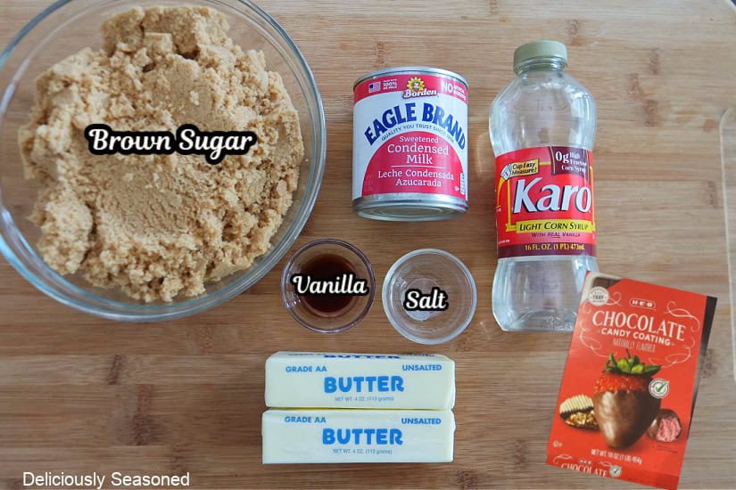 A wood surface with the ingredients to make chocolate covered caramels.