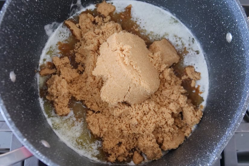A pan with melted butter and brown sugar in it.