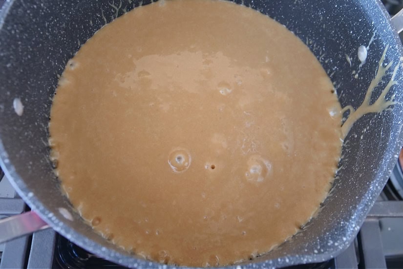 A pan with the caramel mixture starting to boil.