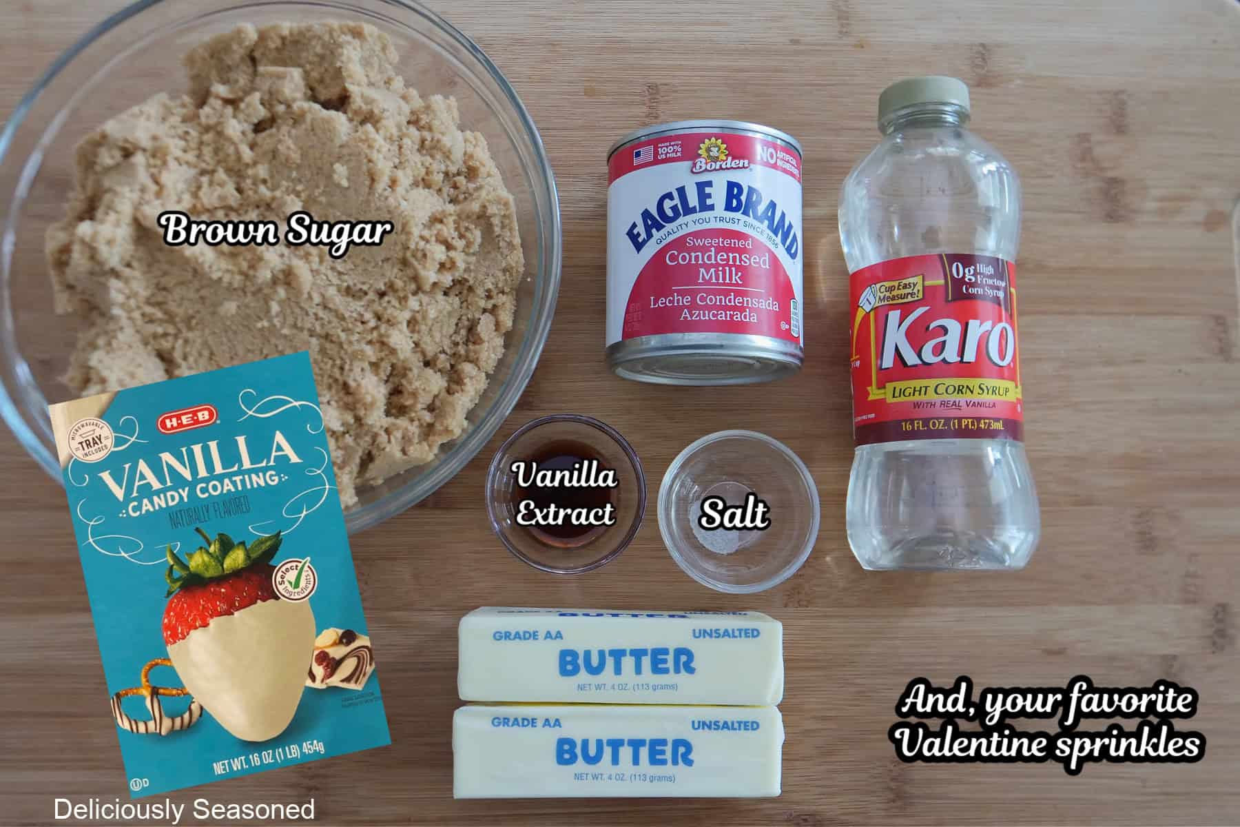 A wood surface with all the ingredients needed to make heart-shaped caramel placed on it.