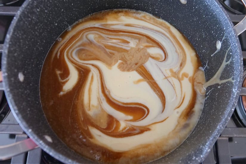 A pan with homemade caramel ingredients in it.