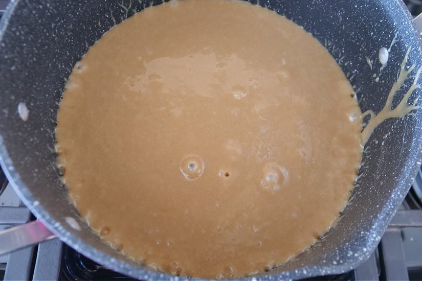 A pan with homemade caramel starting to boil.