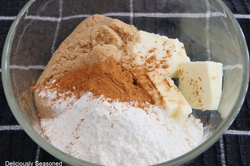 A glass bowl with butter, brown sugar, cinnamon, and flour in it for the streusel filling.
