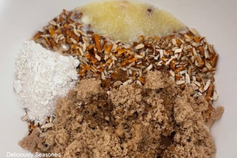 A mixing bowl with pretzel crust ingredients in it before being mixed together.