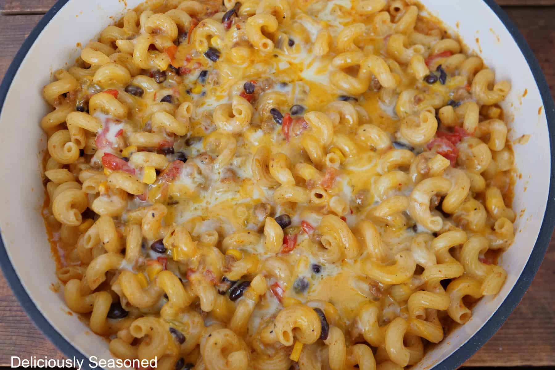 A pan with cheesy southwest chorizo pasta in it after being removed from the oven showing all the melty cheese.