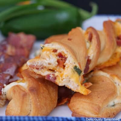 A white plate with three jalapeno popper crescent twists on it.