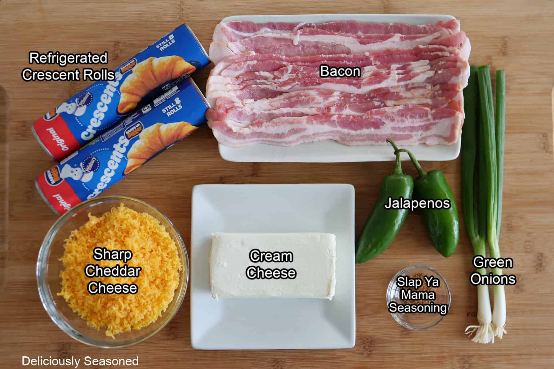 A wood surface with all the ingredients on it to make cheesy jalapeno popper twists.