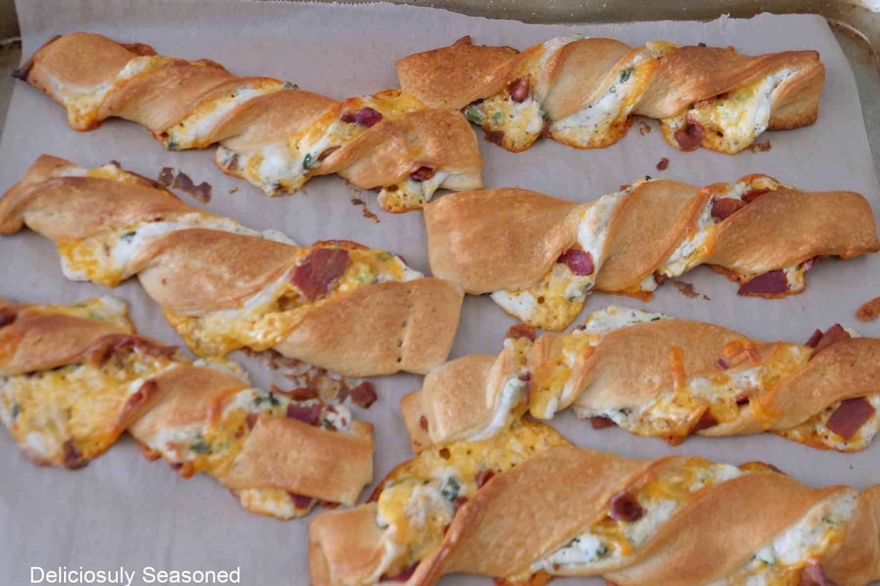 Baked jalapeno popper twists on a baking sheet.
