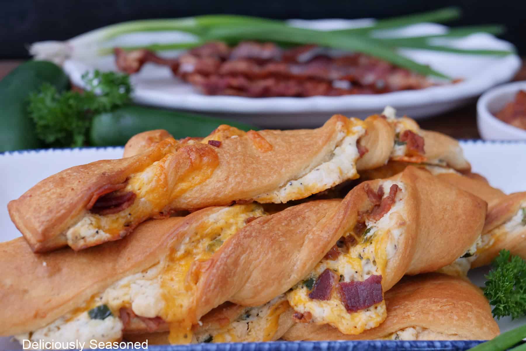 A white plate with 4 jalapeno popper crescent twists on it.