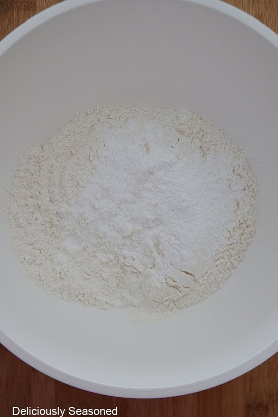 A white bowl with the dry baking ingredients in it before being whisked together.
