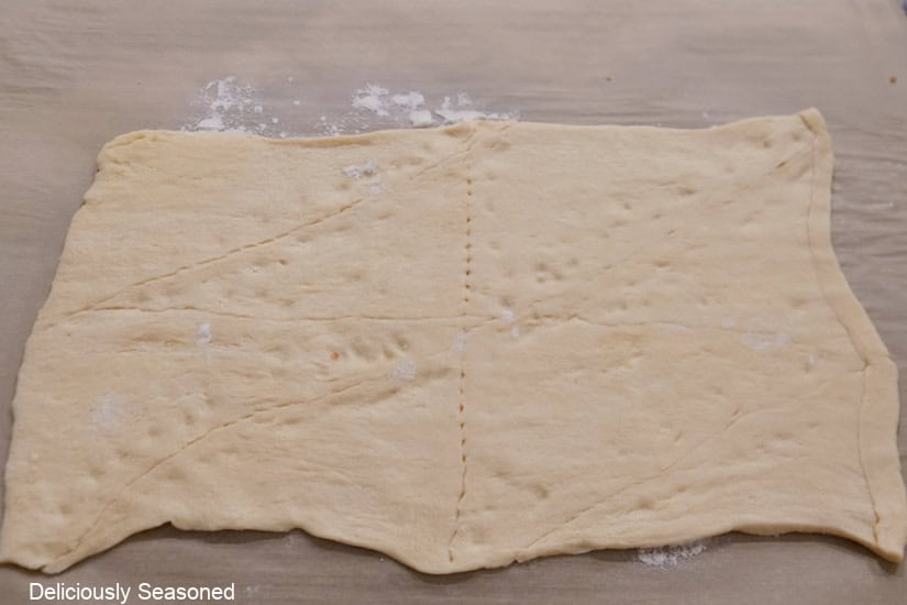 Crescent dough with seams pinched together and rolled out flat.