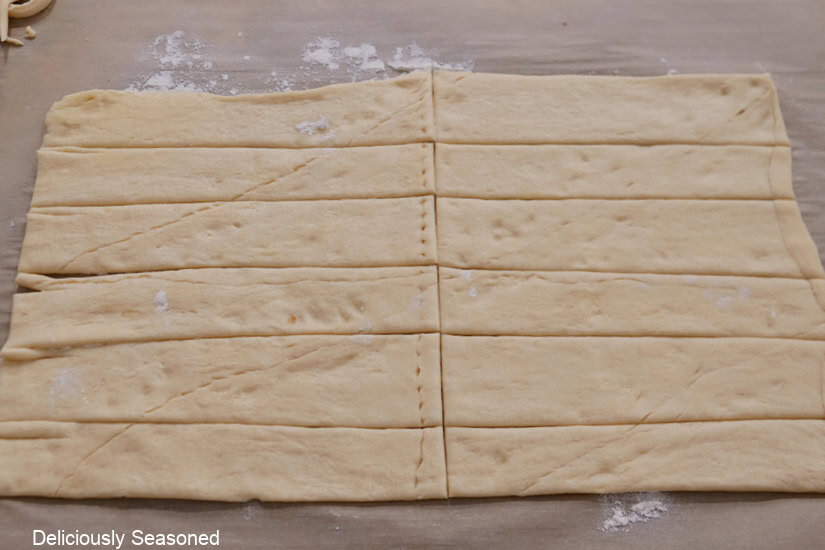 Crescent dough rolled out, trimmed, and cut into 6 long strips and then the strips were cut in half.